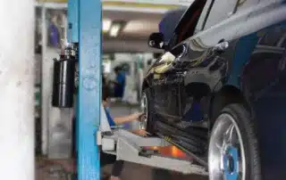 Certified German auto repair technician servicing BMW engine at Carage Auto in Jupiter FL