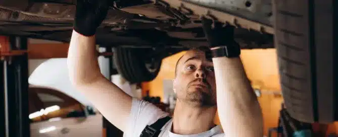 Mechanic inspecting a European luxury car in a professional auto repair shop, debunking common repair myths.