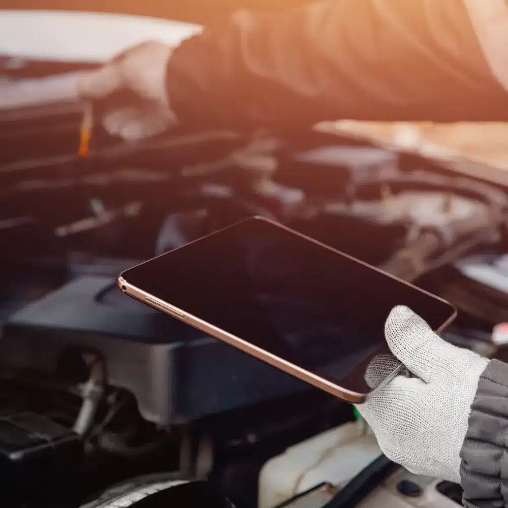 Smiling mechanic at Carage providing transparent and customer-focused auto repair services with a people-first approach