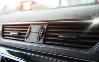 Mechanic performing car AC repair at Carage Auto, a top-rated full-service auto repair shop near you.