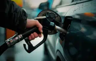 Auto mechanic using diagnostic tools to check a vehicle’s fuel system in a professional repair shop.