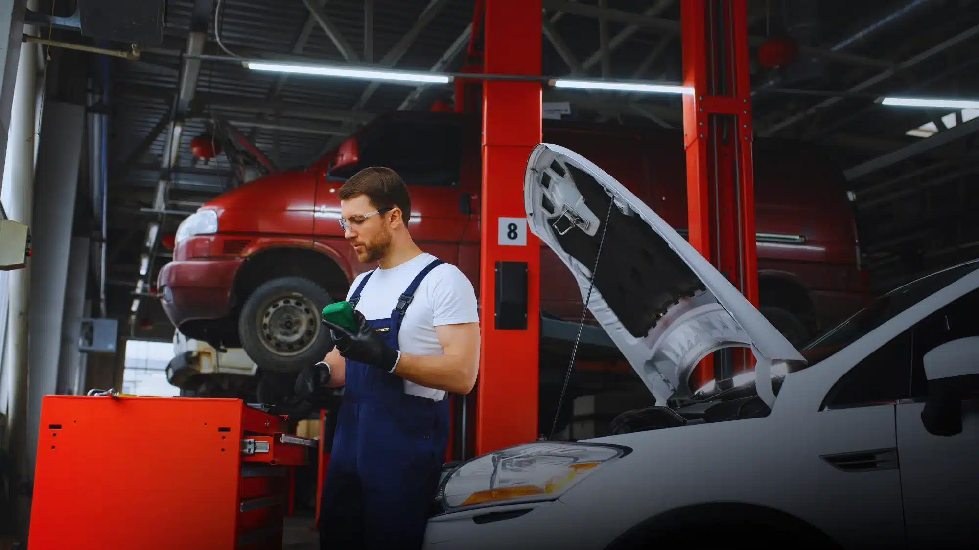Top-rated mechanic at Carage Auto inspecting a car engine inside a clean, professional auto repair shop.