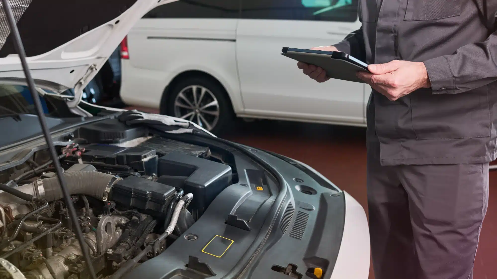 Auto technician performing a comprehensive vehicle inspection to ensure safety and proper maintenance
